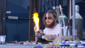 William B. Glass doing the thing he does best in this picture. He is holding his work over the flame.